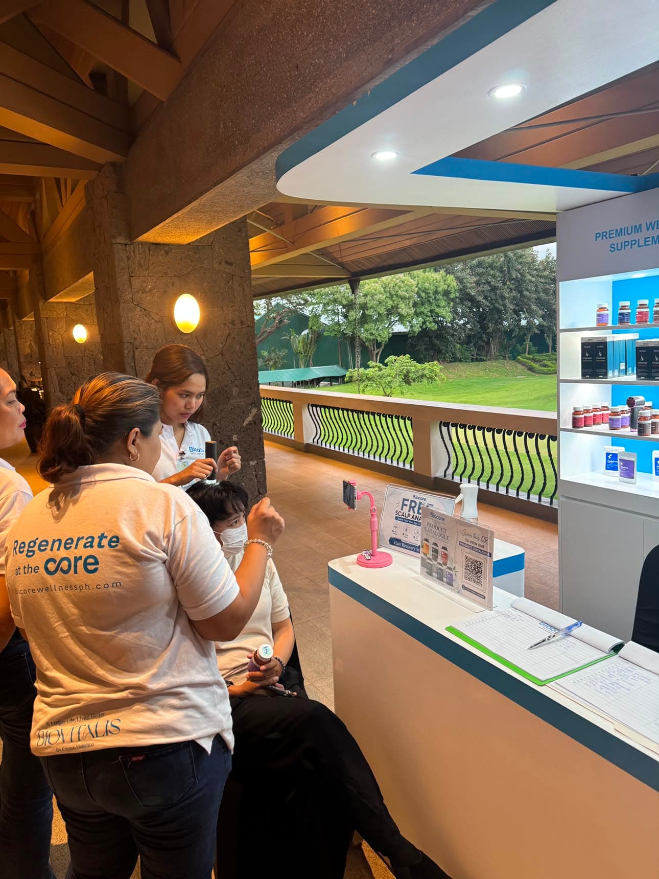 Attendee receiving free scalp and wellness analysis at booth