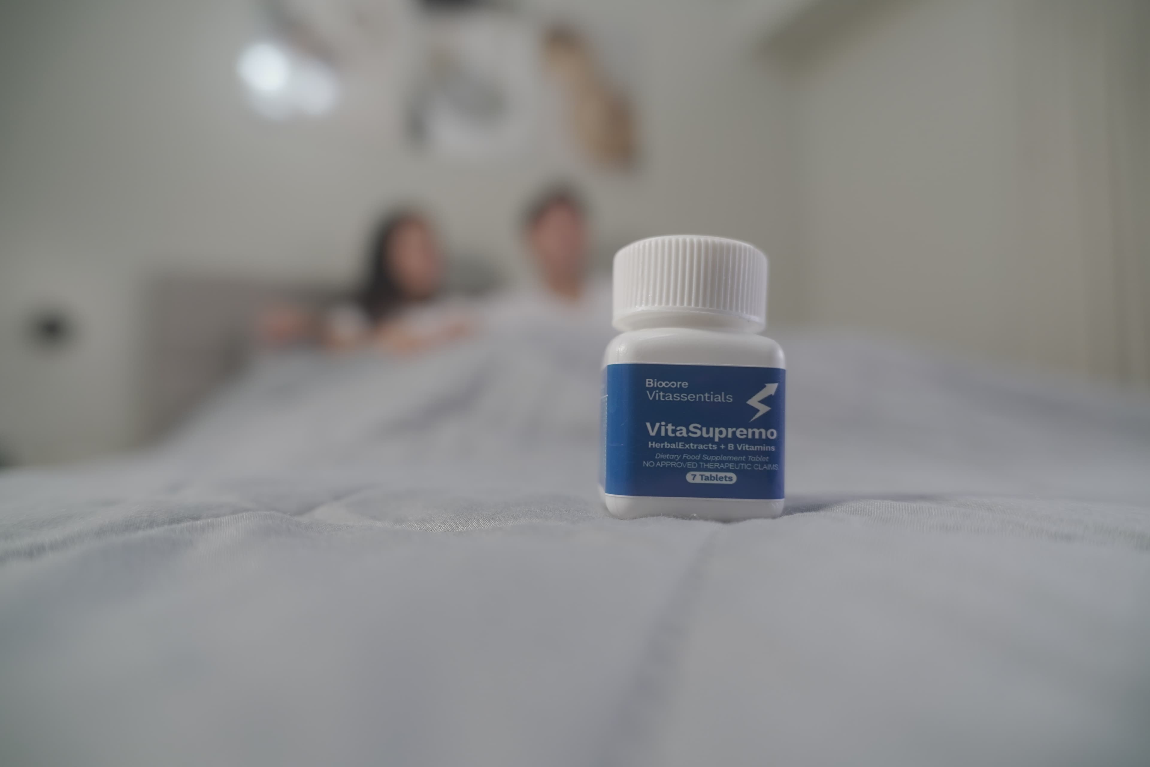 VitaSupremo bottle bedside with active couple relaxing in background