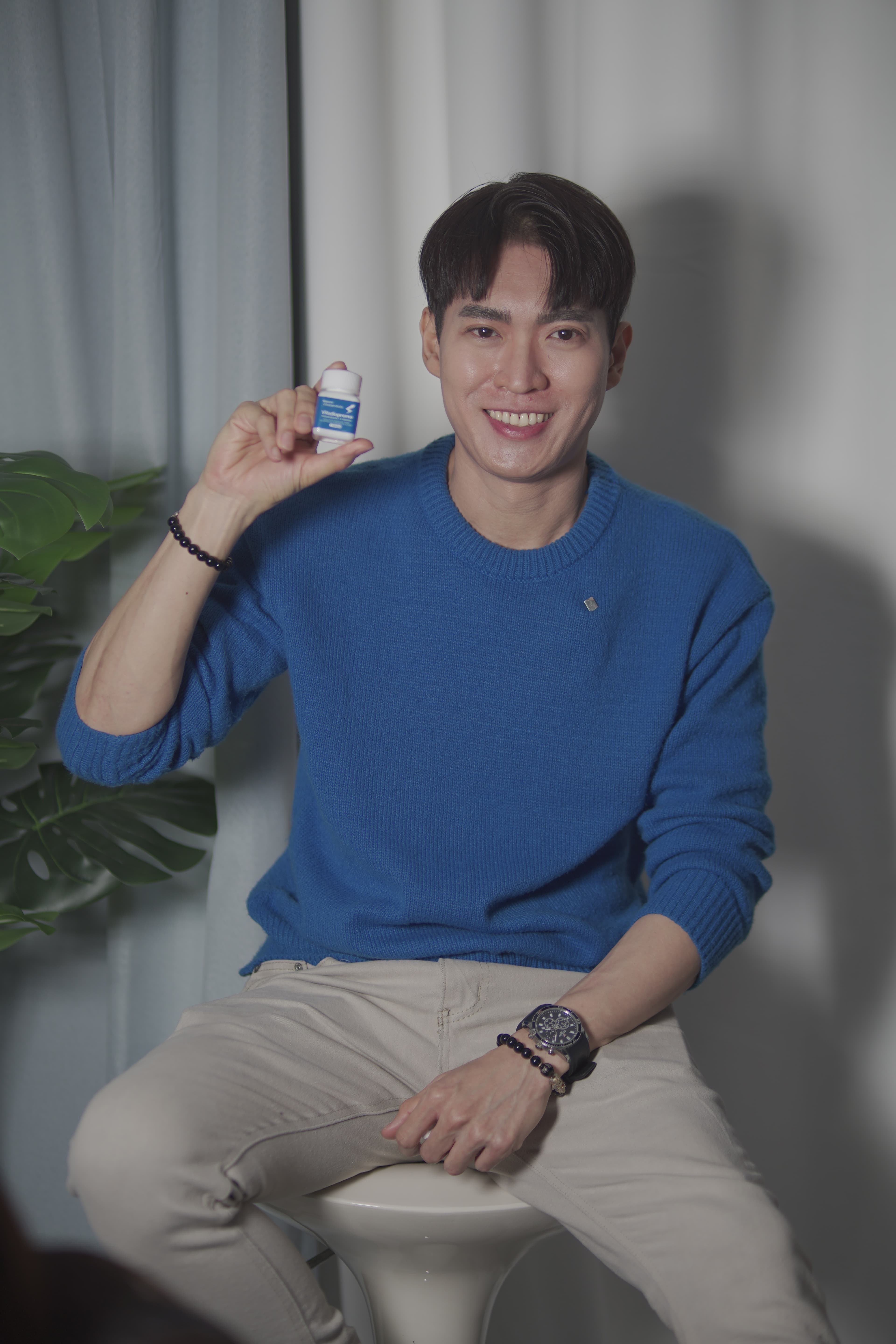 Active male customer in knit sweater holding VitaSupremo