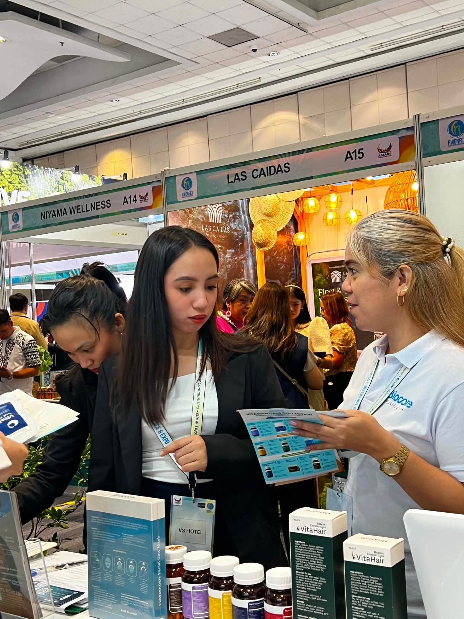 Biocore Wellness expo attendees consulting on supplement formulas