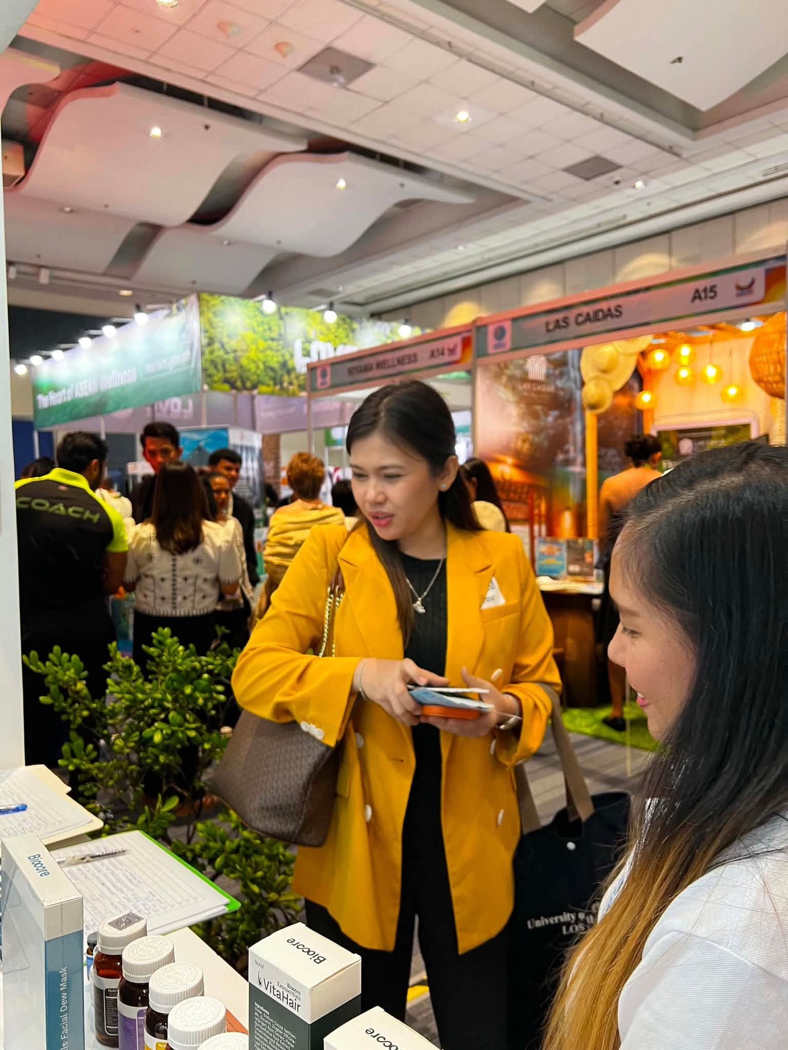 Guest inquiring at Biocore Wellness conference booth